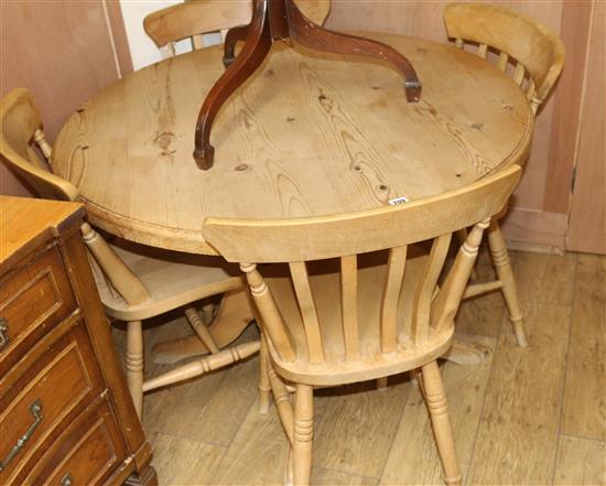A pine table and four chairs W.105cm